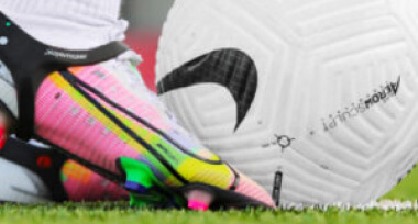 close-up of a soccer player foot hitting a soccer ball