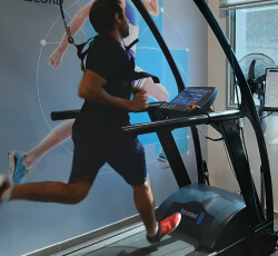 a man is running on a gym machine while his performance is being tracked