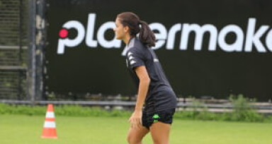 female soccer player walking on a soccer field