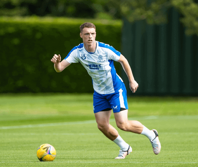 Rangers Football Club's player going towards the ball on a soccer field